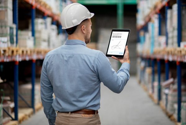 homem usando tecnologia em tablet para controle da logística em dark store